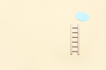 Wooden ladder with cloud on beige background © Pixel-Shot