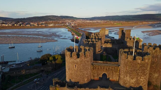 Welsh Flag on Conwy Castle and River Conwy Estuary Drone Aerial 4k