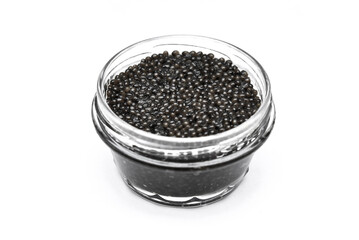 Black caviar in glass jar top view isolated on white background. Sea food, delicacy, small sturgeon caviar