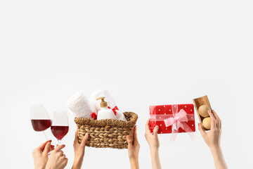 Female hands with spa supplies, wine and gift on white background. Valentine's Day celebration