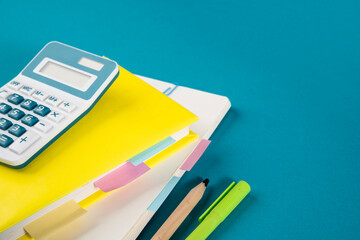 Calculator, textbook, notepad with bookmarks and stickers. The concept of diligent study of...