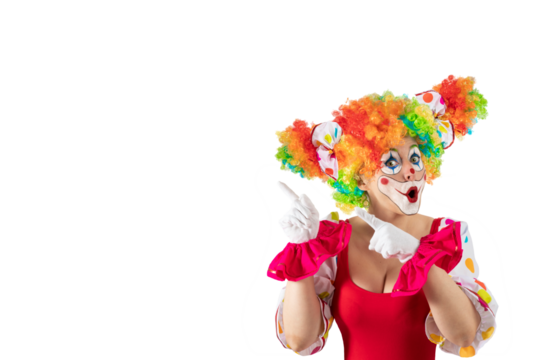 Suprised female clown pointing at blank template copy spase for advertising, posters, greetings, invitations. Entertainer as Joker in a suit and wig, with clown whiteface makeup.