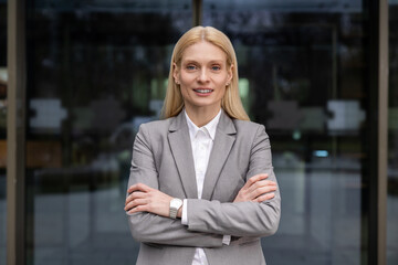 Blonde caucasian business lady in elegant suit looking confident and resolute