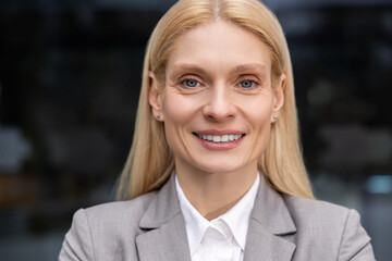 Headshot of a blonde cute caucasian smiling woman