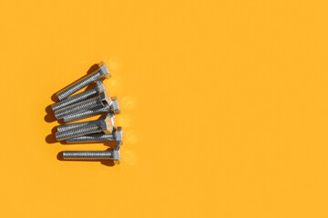 Tap bolts on orange background