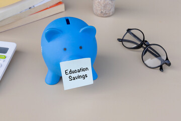A blue piggy bank with an education label, emphasizing financial preparation for learning and...