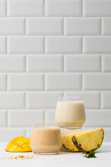 Refreshing tropical smoothie with mango and pineapple in modern kitchen setting
