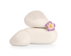 Spa stones and small flower on white background