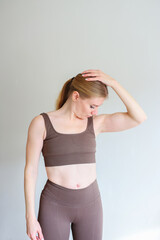 Sporty young woman doing yoga practice isolated on white background - concept of healthy life and...