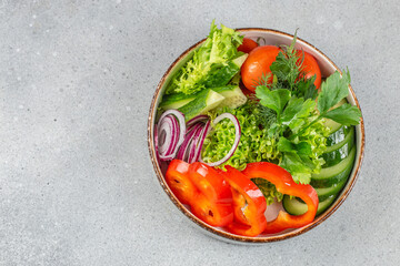 vegan salad from green leaves mix and vegetables in bowl. Healthy green vegetable salad, diet menu. Top view