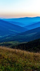 Obraz premium Serene Sunrise Mountain Landscape Rolling Hills Golden Hour