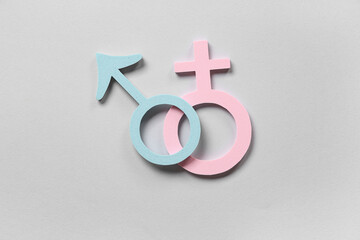 Female and male gender symbols on grey background