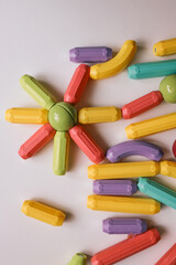 Colorful magnetic construction toy pieces arranged in a flower shape on a white background. Educational and creative play for kids, promoting fine motor skills and imagination