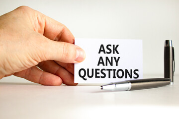 Ask any questions symbol. Concept words Ask any questions on beautiful white card. Beautiful white background. Businessman hand. Business ask any questions concept. Copy space.