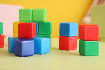 Obraz premium Colorful cubes on table in children's room, closeup