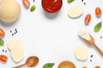 Frame made of raw dough and ingredients for preparing pizza with mozzarella on white background