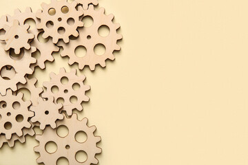 Wooden gears on beige background