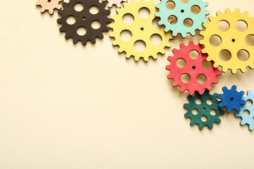 Wooden gears on beige background