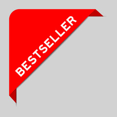 Red color of corner label banner with word bestseller on gray background