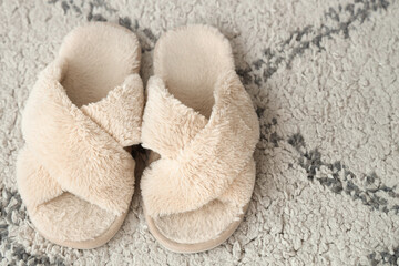 Soft slippers on carpet, top view