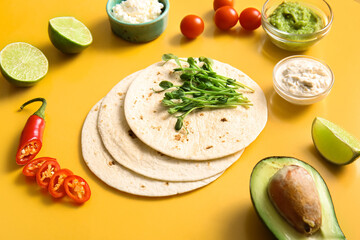 Ingredients for tasty fresh taco on yellow background