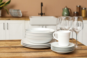 Clean dishes on wooden table in kitchen