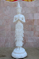Carved sculpture art deity statue or angel figure lanna style for thai people traveler travel visit and respect praying blessing wish myth holy worship at Wat Khua Khrae temple in Chiang Rai, Thailand