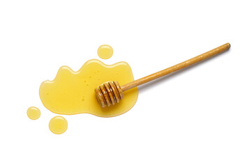 Spilled sweet honey and wooden dipper isolated on white background
