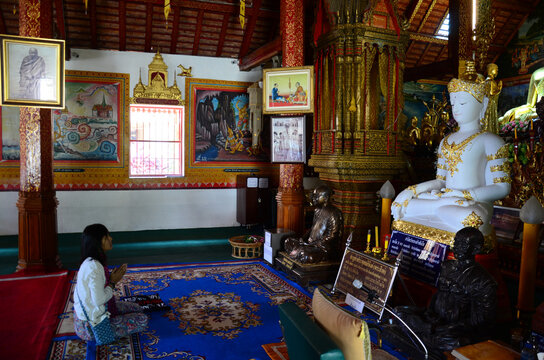 Thai travelers women people travel visit respect praying blessing wish myth holy mystical worship ancient Phra Sing buddha statue of Wat Phra Singh temple on February 24, 2015 in Chiang Rai, Thailand