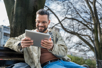 Fototapeta premium Young cool hipster freelance business man, owner of small startup company new business on market representative, waiting outside of office building for staff meeting. Design professional occupation.