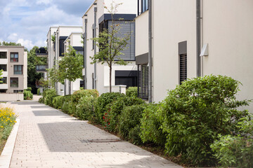 Residential Buildings Landscaping in Germany. Modern Apartment Buildings with Green Bushes and...