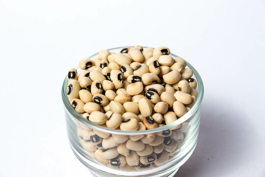 Closeup of Black-eyed peas in a Glass bowl Isolated on a white background. Black-eyed peas, also known as black-eyed beans or cowpeas, are a type of legume. 
