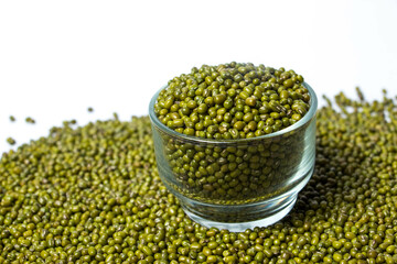 Green Moong Dal beans in a Glass Bowl Isolated on a white background. The mung bean or green gram (Vigna radiata).