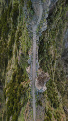 A stone staircase winding along the mountain ridge at Pico do Arieiro, Madeira, Portugal, captured from above