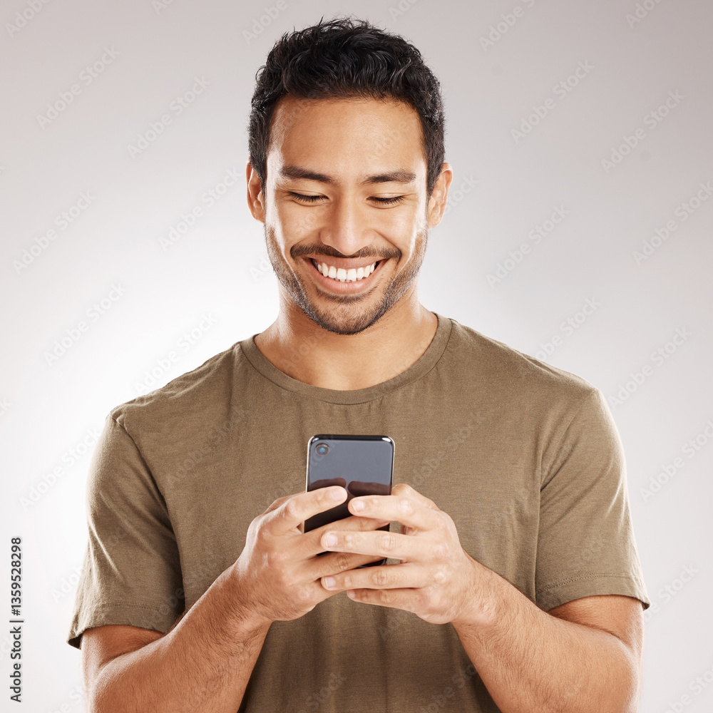 Poster Man, typing and happy with phone in studio for playing online game, gambling app and internet search. Website, person and smile with smartphone on gray background for streaming service and connection
