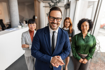 Diverse Team of Professionals Smiling in Modern Office Setting