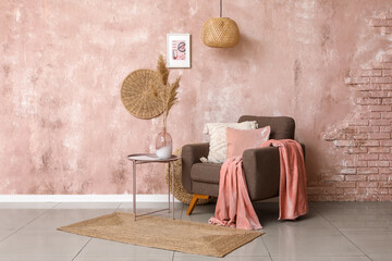 Interior of stylish living room with brown armchair and pampas grass on coffee table