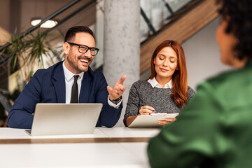 Professional Team Holding a Discussion in Modern Office Setting