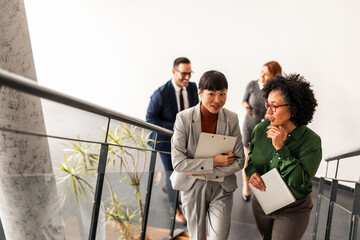 Professional Coworkers Sharing Ideas While Walking in a Modern Office