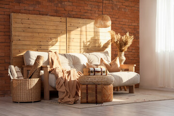 Interior of living room with couch, vintage suitcases and folding screen