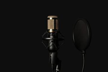 Stand with professional microphone on black background, closeup