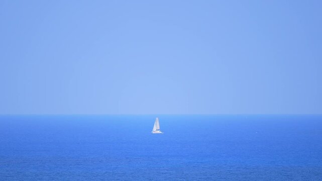 White parus ship on the blue ocean. Sail rock grew from depths of world against backdrop of Crimean mountains emerging from water. Pleasure boat in sea near the cliff Parus. Black sea waves of emerald
