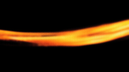 Grain noise texture Abstract Golden, blurry light trail on a stark black background
