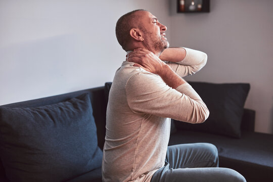 Man with neck pain at home.