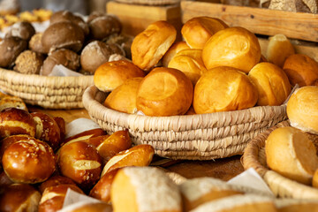 Luxury hotel breakfast buffet with fresh baked bread rolls, artisan pastries and pretzels in rustic wicker baskets