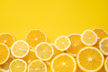 Fresh citrus slices on vibrant yellow background