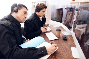 Two men work as guards.