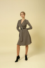 Serie of studio photos of female model in patterned brown midi dress, autumn winter fashion...
