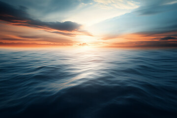 Fototapeta premium Ocean waves under a vibrant sunset sky. The horizon is a fiery mix of orange and blue.
