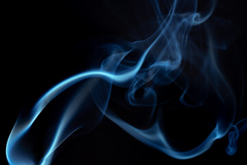 Wispy blue smoke wave flowing against a black background, creating a sense of mystery and elegance. Abstract and atmospheric concept. Concept of mystery and creativity. Swirling smoke to overlay